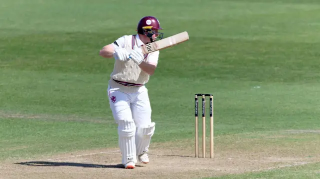 Somerset wicket-keeper James Rew plays a shot down to third man.