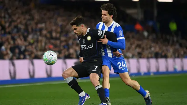 Pedro Neto of Chelsea shields the ball while under pressure from Ferdi Kadioglu