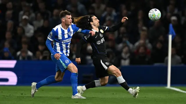 Marc Cucurella of Chelsea is challenged by Pascal Gross of Brighton & Hove Albion