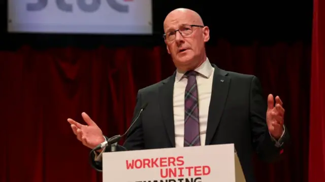 First Minister John Swinney addresses delegates during the STUC conference in the Caird Hall, Dundee