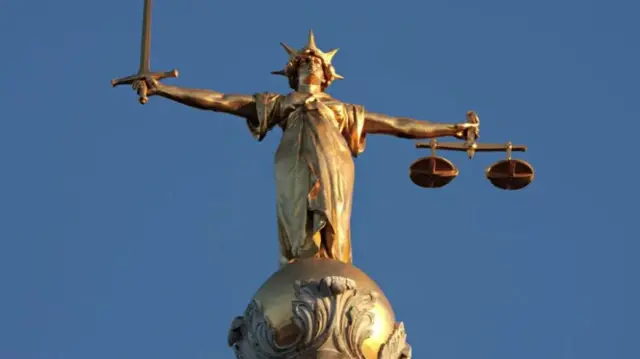 The statue of Lady Justice atop the Old Bailey in London, representing the legal system and justice.