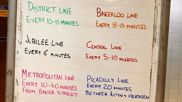 A whiteboard which lists the tube lines and how often their trains come. Northern: every 15 min. Victoria: every 5 min. District: 10-15 min. Bakerloo: 8-15. Jubilee: every 6. Central: every 5-10. Metropolitan every 10-40. Piccadilly: every 20