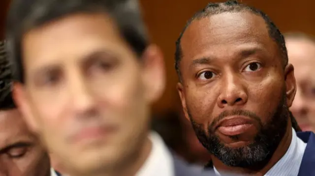 Larry Fitzgerald Jr sits behind Warsh