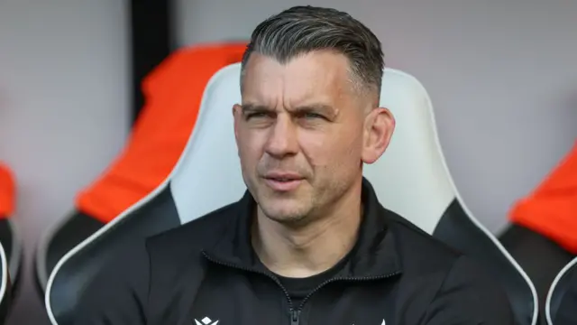 Matt Bloomfield, wearing a black Oxford United jacket, during the game at Derby
