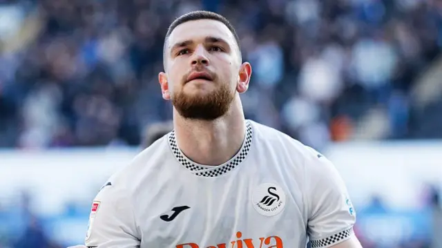 Swansea City striker Zan Vipotnik celebrating scoring a goal.