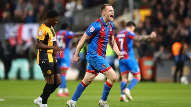Cameron McJannet of Grimsby Town celebrates after final whistle at Cambridge United