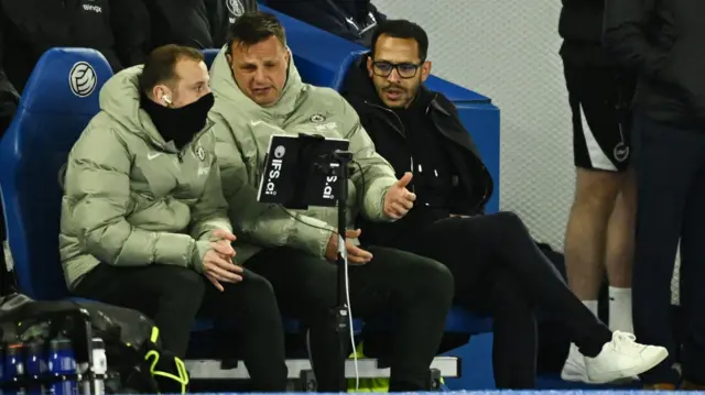 Liam Rosenior consults his coaching staff