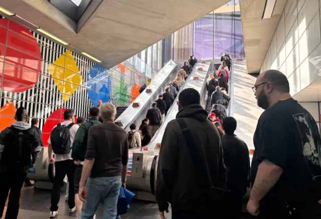 People queuing up escalators at Tottenham Court Road station