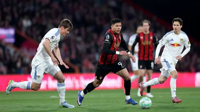 Evanilson of AFC Bournemouth runs with the ball under pressure from Jaka Bijol of Leeds United