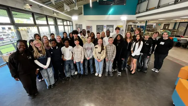 A group of young people posing for a photograph in BBC studios.