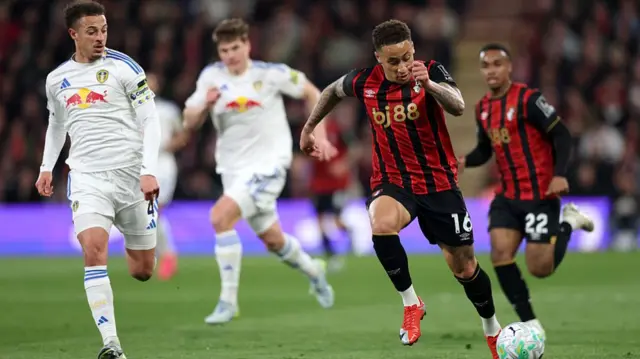 Marcus Tavernier of AFC Bournemouth runs with the ball under pressure from Ethan Ampadu of Leeds United