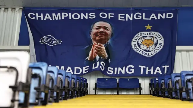 A banner showing Vichai with the words "Champions of England - you made us sing that"