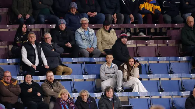 Fans of Burnley sit among empty seats