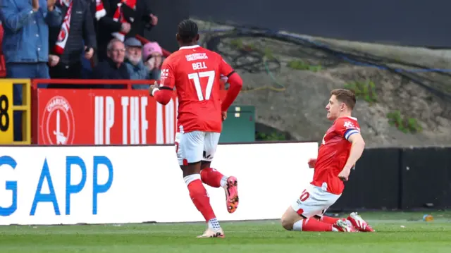 Greg Docherty sliding on his knees to celebrate his goal for Charlton