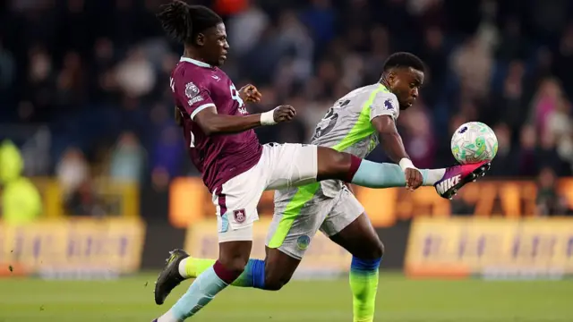 Loum Tchaouna of Burnley controls the ball while under pressure from Marc Guehi of Manchester City