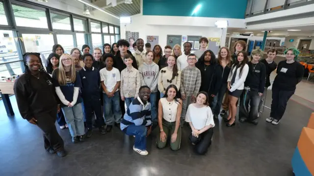 A group of young people posing for a photo in the BBC studios.