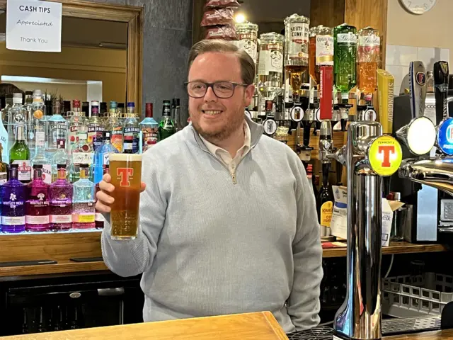 Thomas Kerr in the Woodend pub in Mount Vernon, Glasgow holds a pint