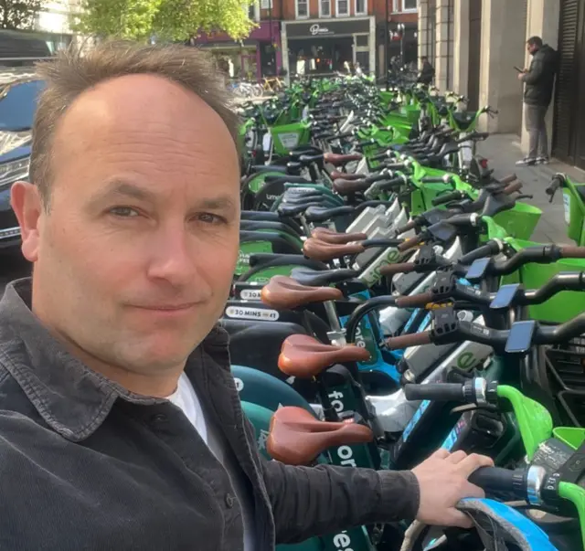 Tom Edwards at an e-bike station