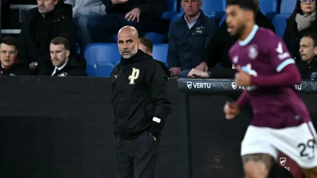 Pep Guardiola looks on