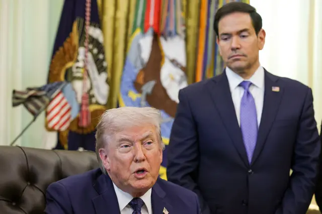 Marco Rubio looks down at Donald Trump