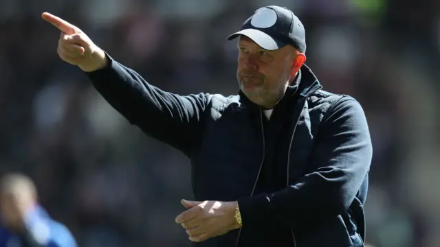 Bromley manager Andy Woodman points after the full-time whistle against MK Dons