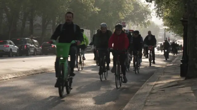 People cycling along a cycle lane in London