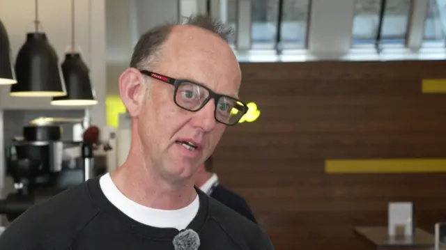 Peter Dore-Smith speaks to the BBC inside one of his Kaffeine coffee shops in Fitzrovia