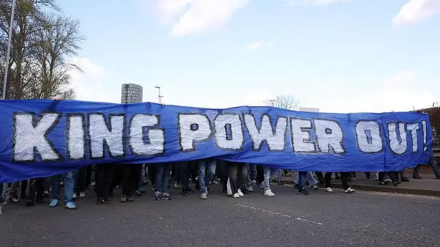 Leicester fans protest against the ownership of the club with a King Power Out banner in white letters on a blue background
