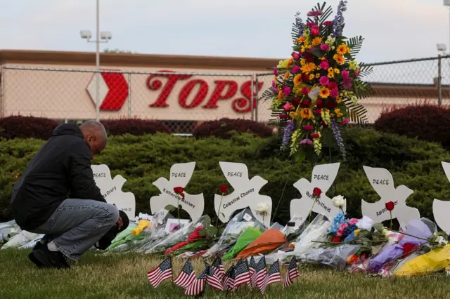 Tributes at the scene of a mass shooting in front of a US supermarket