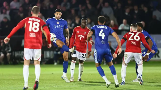 Salford and Bromley players challenge for the ball