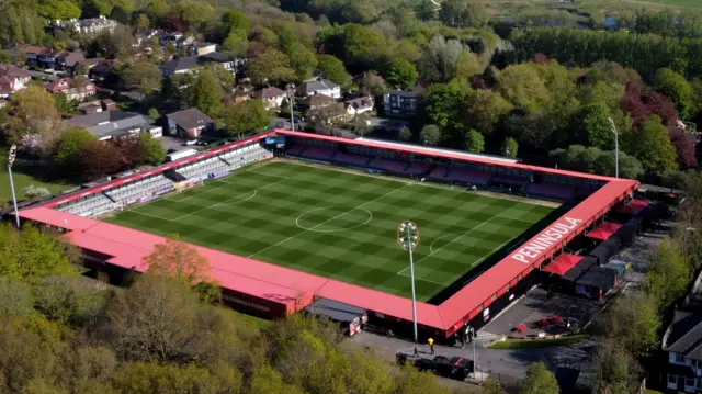 Aerial shot of Salford City's Peninsula Stadium on a sunny evening