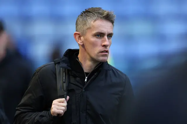 Ipswich boss Kieran McKenna walking into a stadium with a rucksack over his shoulder