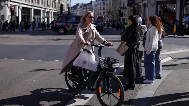 Woman on a rental bike in Oxford Circus on 23 April