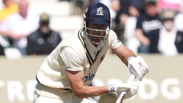Warwickshire player Beau Webster plays a shot while batting