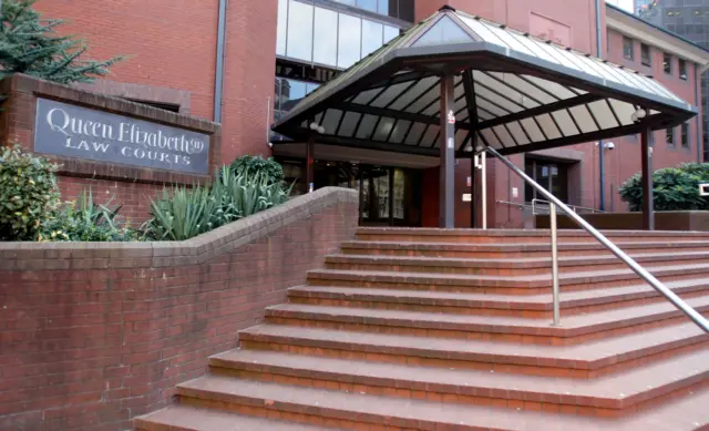 Red brick steps lead up to the exterior of Birmingham Crown Court