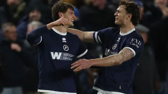 Caleb Taylor and Jake Cooper go to hug after Taylor scores for Millwall