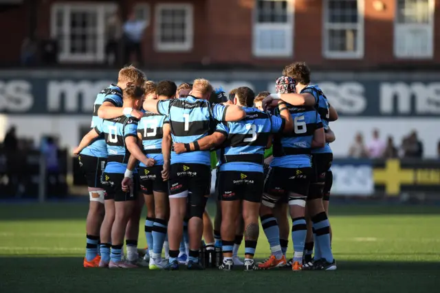 Cardiff players in a group huddle