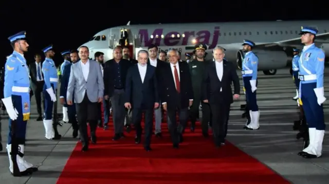 A handout photo made available by Pakistan's Foreign Office shows Iranian Foreign Minister Abbas Araghchi (C) walking with Pakistan's Deputy Prime Minister Ishaq Dar (R) and Field Marshal Asim Munir at Nur Khan Airbase in Rawalpindi, Pakistan