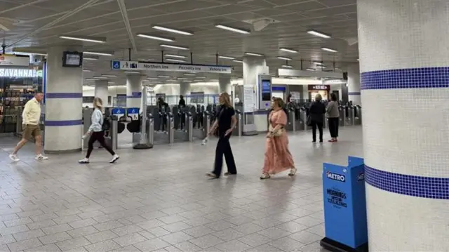 People walking through a quiet King's Cross station