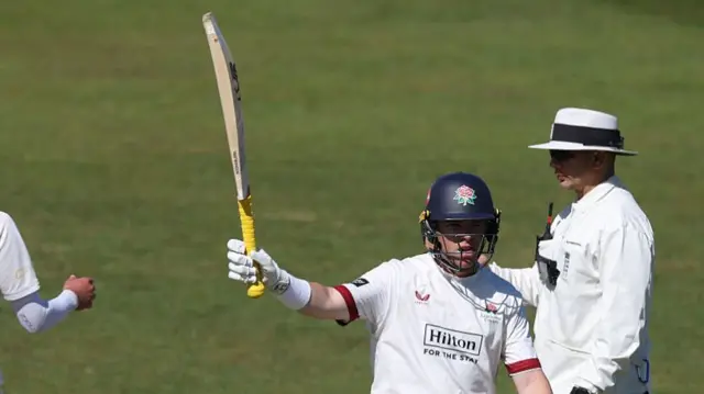 Lancashire batsman Marcus Harris raising his bat.