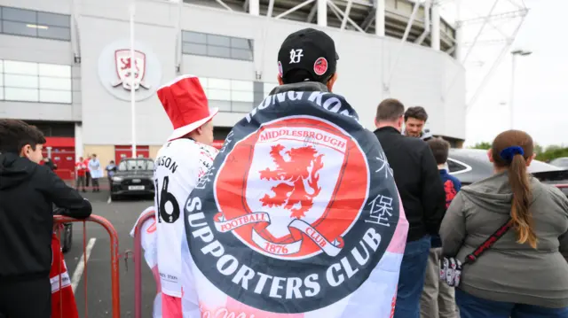 A Middlesbrough fan from Hong Kong with a banner on his back