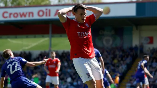 Ryan Fallowfield has his head in his hands after a chance goes begging
