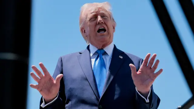 US President Donald Trump speaks to the media outside Air Force One