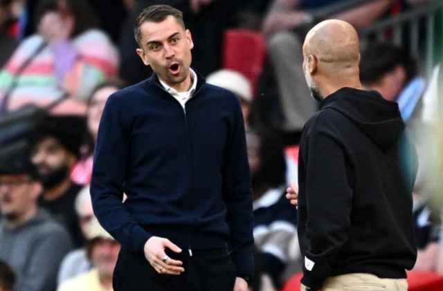Manchester City manager Pep Guardiola speaks with Southampton manager Tonda Eckert