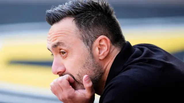 Tottenham Hotspur manager Roberto De Zerbi looks on