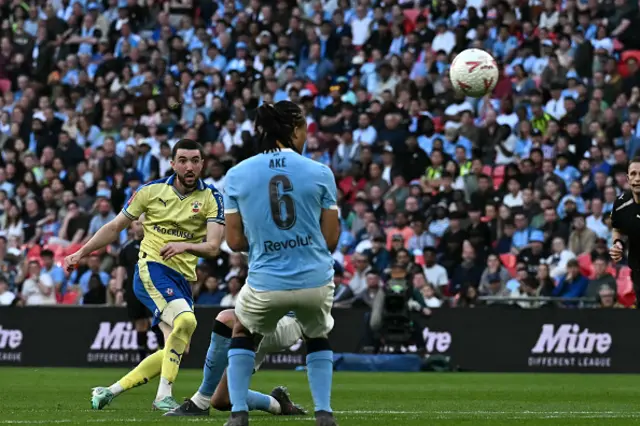 Finn Azaz (L) shoots to score the opening goal