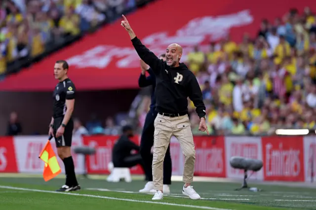 Pep Guardiola, Manager of Manchester City, reacts