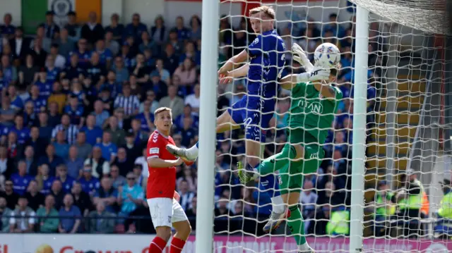 Rochdale's Dan Moss (centre) fouls York City goalkeeper Harrison Male i