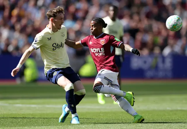 James Garner of Everton clears the ball away from Crysencio Summerville