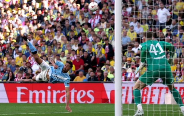 Manchester City's Tijjani Reijnders shoots at goal